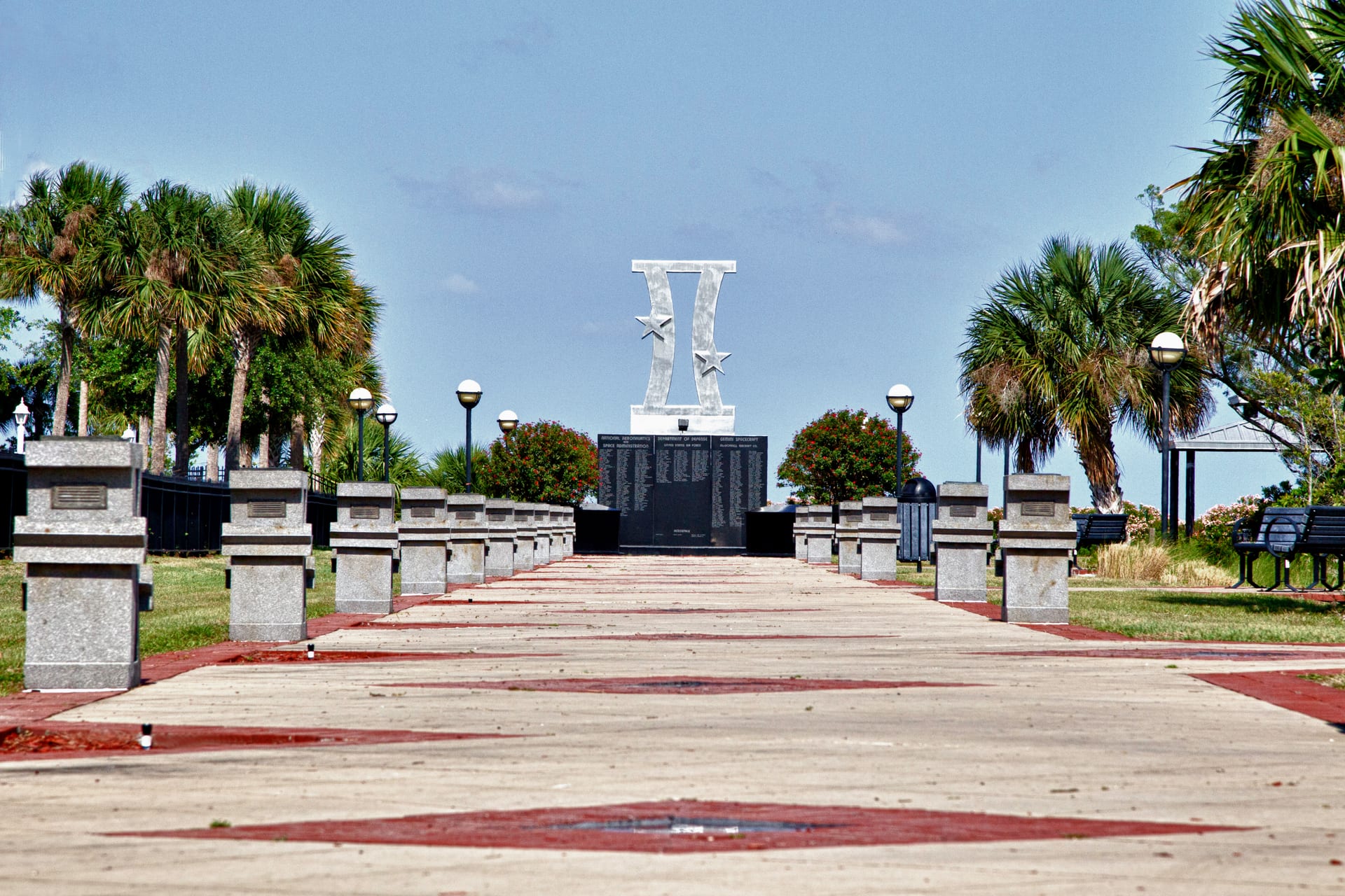 Space Walk of Fame monuments recede along a riverside walkway.